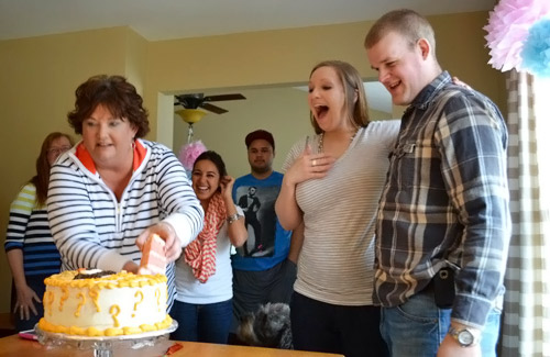 Cutting their gender reveal cake... it's a girl!