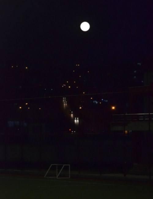 Full moon over a soccer field